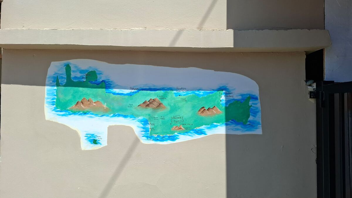 Hand-painted map of Crete on the villa wall with Vagionia marked