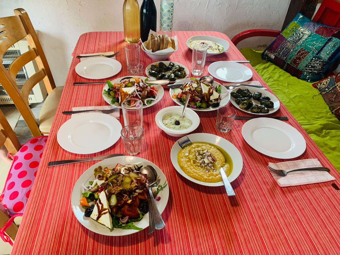 The family table set with salads, dolmades, fava and tzatziki
