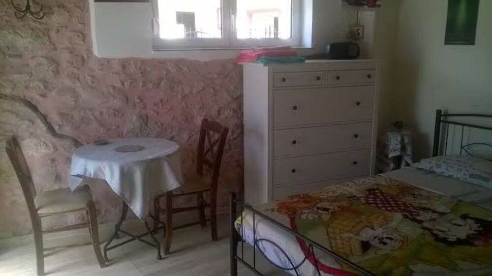 Room Kostas — double room with exposed stone wall